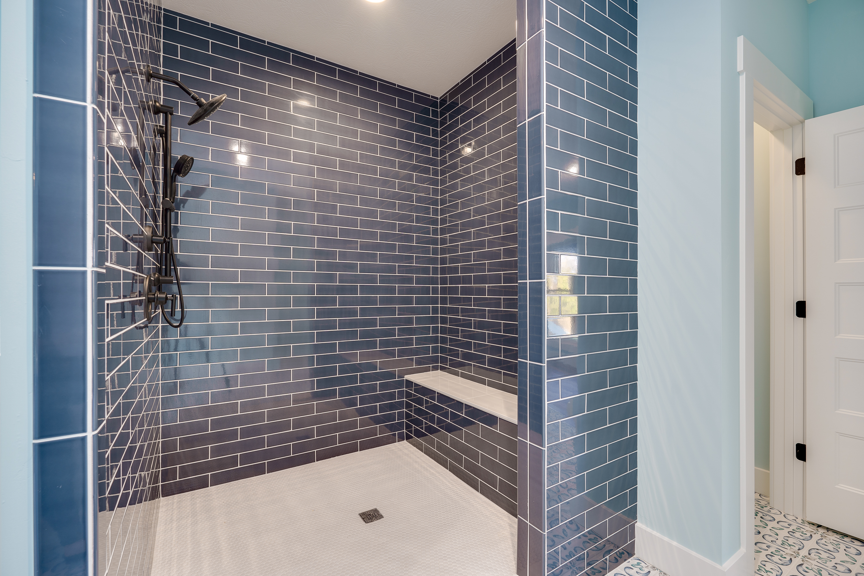 Custom bathroom renovation with navy blue subway tile shower, Springboro Ohio