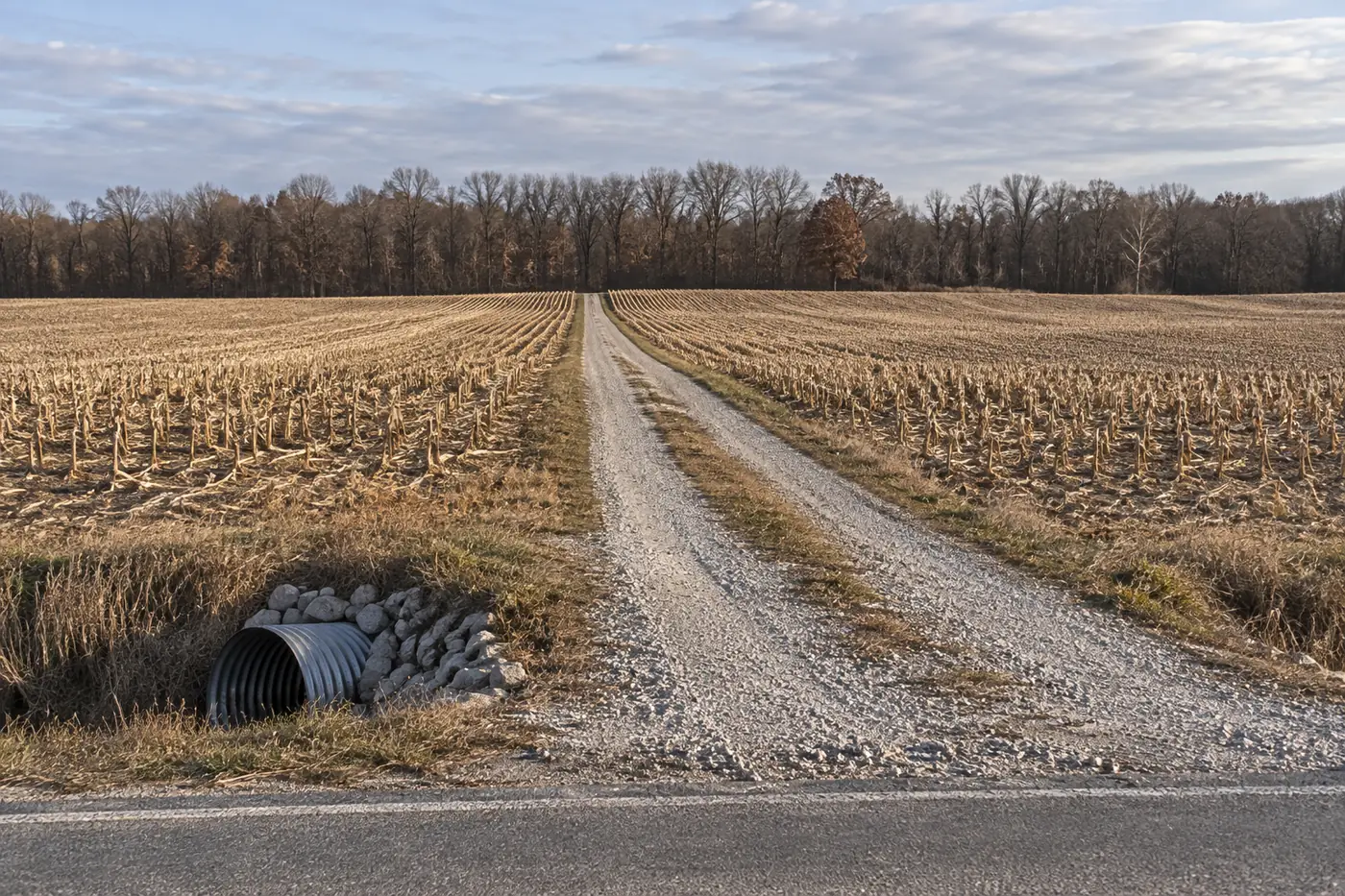 Long gravel driveway and culvert crossing into a rural building parcel in Preble County, Ohio